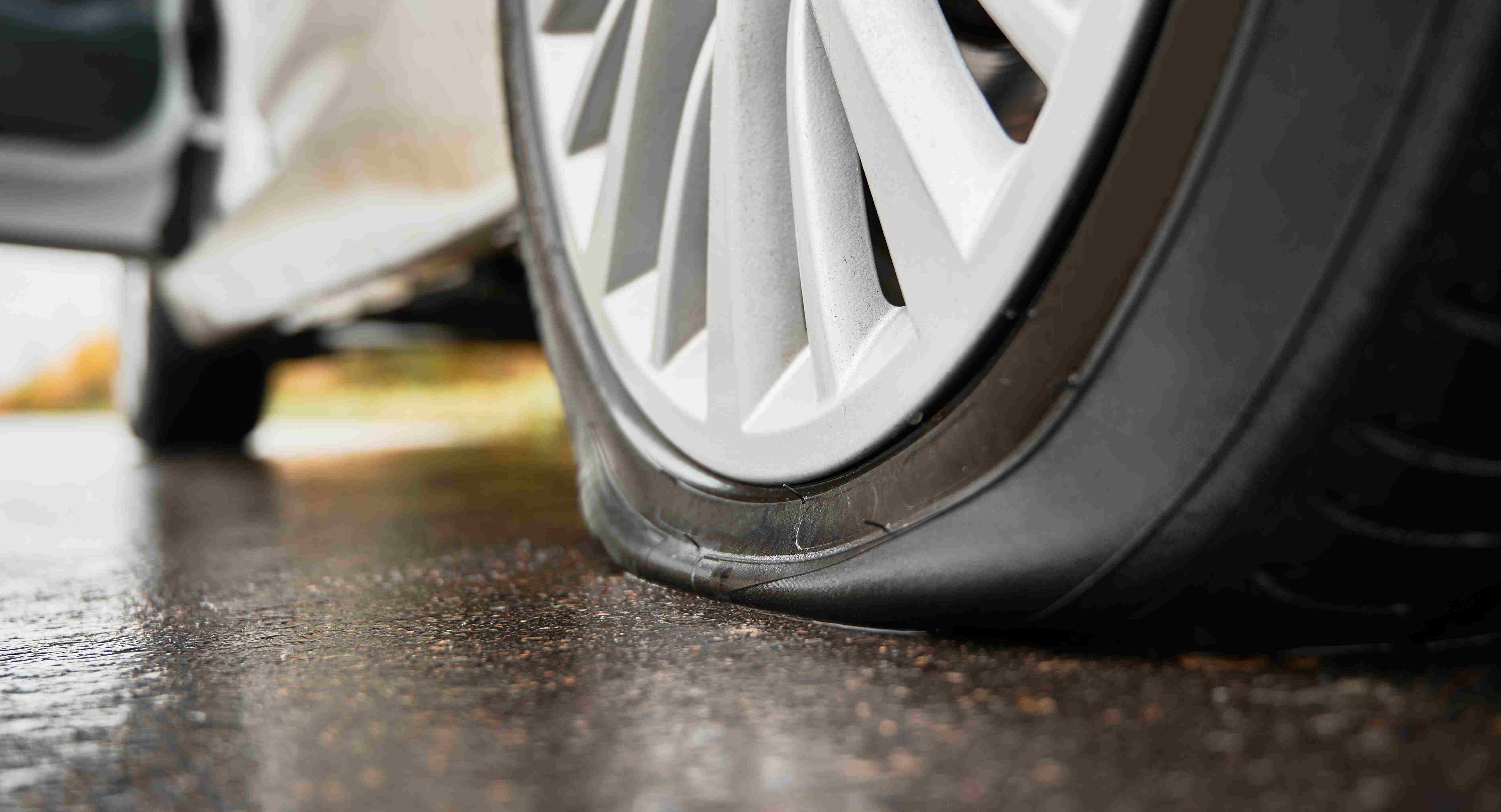 a man checking the condition of tyre